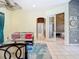 Bright living room with tile floors, stylish decor, and seamless flow to other areas at 6594 Buckboard St, North Port, FL 34291