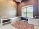Bright office space featuring custom built-ins, large window, and tile floors at 6594 Buckboard St, North Port, FL 34291