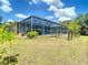 Home featuring a screened-in pool area with plenty of room for patio furniture and entertaining at 6594 Buckboard St, North Port, FL 34291