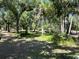 Scenic property featuring a mix of mature trees and shaded areas at 6594 Buckboard St, North Port, FL 34291