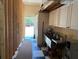 Functional utility room with sink, storage, and open access to the outdoors at 6594 Buckboard St, North Port, FL 34291