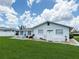 Backyard with ample green space, white fencing, and patio, perfect for outdoor activities at 724 Hartford Nw Dr, Port Charlotte, FL 33952