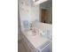 Bright bathroom vanity features seashell art, a large mirror, ample counter space, and vanity storage at 724 Hartford Nw Dr, Port Charlotte, FL 33952