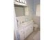 Bright bathroom features a well-lit mirror, modern fixtures, and clean, coastal-inspired decor at 724 Hartford Nw Dr, Port Charlotte, FL 33952