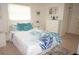 Bright bedroom with coastal-themed decor, a comfortable bed, and plenty of storage space at 724 Hartford Nw Dr, Port Charlotte, FL 33952