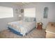 Comfortable bedroom offers a queen-sized bed with beach-themed decor, side tables, and natural light at 724 Hartford Nw Dr, Port Charlotte, FL 33952