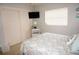 Serene bedroom features a closet, queen-sized bed, and accent table with coastal-themed decor at 724 Hartford Nw Dr, Port Charlotte, FL 33952