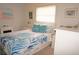 Tranquil bedroom featuring a comfortable bed, coastal artwork, and natural light from a large window at 724 Hartford Nw Dr, Port Charlotte, FL 33952