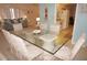 Dining area featuring a glass table with seating for six, flowing into the living room and kitchen at 724 Hartford Nw Dr, Port Charlotte, FL 33952