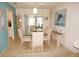 Elegant dining area with a glass-top table, patterned chairs and serene artwork at 724 Hartford Nw Dr, Port Charlotte, FL 33952