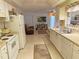 Functional kitchen with white appliances and a view into the adjacent living area at 724 Hartford Nw Dr, Port Charlotte, FL 33952