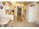 Bright kitchen with white cabinets, a dining table, and appliances; includes an open view to the dining room at 724 Hartford Nw Dr, Port Charlotte, FL 33952
