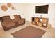 Relaxing living room features a plush recliner, a wall-mounted TV, and stylish decor at 724 Hartford Nw Dr, Port Charlotte, FL 33952