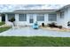 Back patio with comfortable seating and serene landscaping, ideal for relaxing outdoors at 724 Hartford Nw Dr, Port Charlotte, FL 33952