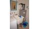Utility sink with faucet, water heater, and storage; perfect for laundry and cleaning needs at 724 Hartford Nw Dr, Port Charlotte, FL 33952