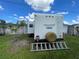 Flagstaff Classic camper with spare tire and ladder for access on a grass lot at 2336 Picnic St, Port Charlotte, FL 33952