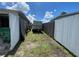 Side yard of the property showing ample space between fences at 2336 Picnic St, Port Charlotte, FL 33952