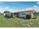 Expansive backyard features a screened-in patio, landscaped garden beds, and a well-maintained lawn at 1107 Seneca Rd, Venice, FL 34293