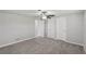 Bedroom featuring plush carpeting, a ceiling fan, and multiple closets at 1107 Seneca Rd, Venice, FL 34293