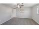 Comfortable bedroom with carpeted floor, neutral walls, ceiling fan, and natural light from two windows at 1107 Seneca Rd, Venice, FL 34293