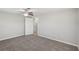 Spacious bedroom featuring neutral carpet, a ceiling fan, and access to other rooms at 1107 Seneca Rd, Venice, FL 34293