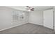 Bright bedroom featuring a window, a ceiling fan, and plush carpeting at 1107 Seneca Rd, Venice, FL 34293
