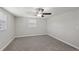 Bright bedroom with neutral paint, plush carpet, ceiling fan, and window providing ample natural light at 1107 Seneca Rd, Venice, FL 34293