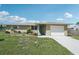 Attractive one-story residence showcasing a freshly painted exterior and landscaped garden beds, offering serene living at 1107 Seneca Rd, Venice, FL 34293