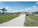 Inviting single-Gathering home boasting a neat front yard and a convenient attached garage, perfect for modern living at 1107 Seneca Rd, Venice, FL 34293