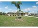 Lovely home with a well-maintained lawn, mature trees, and a paved driveway, blending comfort and style at 1107 Seneca Rd, Venice, FL 34293