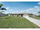 Charming one-story home featuring a well-manicured lawn and an attached garage, creating a welcoming curb appeal at 1107 Seneca Rd, Venice, FL 34293