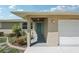 Close-up of the front entry highlighting a stylish door, manicured landscaping, and a welcoming entrance at 1107 Seneca Rd, Venice, FL 34293