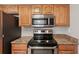 Modern kitchen featuring stainless steel appliances and granite countertops at 1107 Seneca Rd, Venice, FL 34293