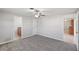 The main bedroom with gray carpet has 2 entrances, one to the bathroom and one to the kitchen at 1107 Seneca Rd, Venice, FL 34293
