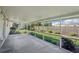 Relaxing screened-in patio with view of landscaped backyard and privacy fence at 1107 Seneca Rd, Venice, FL 34293
