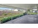 Screened patio with view of a fenced-in yard with lush green grass and garden beds at 1107 Seneca Rd, Venice, FL 34293