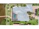Aerial view of house showcasing roof, pool, screened lanai, and lush landscaping at 119 Creek Se Dr, Port Charlotte, FL 33952
