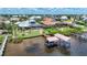 Beautiful backyard with large, screened-in pool and boat dock on the water at 119 Creek Se Dr, Port Charlotte, FL 33952