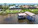Waterfront home features a private boat lift, pool, and well-manicured lawn at 119 Creek Se Dr, Port Charlotte, FL 33952