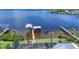 Expansive waterfront view featuring a private boat lift and lush greenery at 119 Creek Se Dr, Port Charlotte, FL 33952