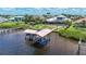 Stunning waterfront residence boasts a private boat lift and verdant landscaping at 119 Creek Se Dr, Port Charlotte, FL 33952