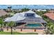 Aerial view of home showcasing lush landscaping, private pool and spa, and screened lanai at 119 Creek Se Dr, Port Charlotte, FL 33952