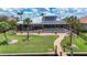 Expansive backyard featuring lush lawn, landscaping, private pool and spa, screened lanai, and access to the water at 119 Creek Se Dr, Port Charlotte, FL 33952