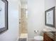 Elegant bathroom featuring travertine tile and a separate shower room at 119 Creek Se Dr, Port Charlotte, FL 33952
