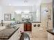 Elegant bathroom featuring granite counters, travertine tile and dual shower heads at 119 Creek Se Dr, Port Charlotte, FL 33952