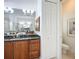 Bathroom with custom cabinet and sink vanity, toilet room, and access to shower at 119 Creek Se Dr, Port Charlotte, FL 33952