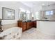 Beautiful bathroom suite with large tub and separate sink vanities and walk-in shower at 119 Creek Se Dr, Port Charlotte, FL 33952