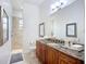 Elegant bathroom featuring wood cabinets, granite counters and a separate shower room at 119 Creek Se Dr, Port Charlotte, FL 33952