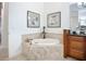A view of a soaking tub, vanity, and access to the shower and toilet at 119 Creek Se Dr, Port Charlotte, FL 33952
