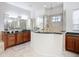Large bathroom with walk-in shower, double sink vanities, and tile floors at 119 Creek Se Dr, Port Charlotte, FL 33952